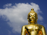Torso and Head Detail of Buddha Statue with Backdrop of Sky and Cloud  Near Chiang Rai