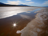 Temporary Waterway in Floor of Death Valley in Winter  with Reflection of Sun in Water