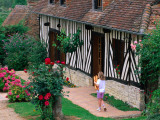 Child with Baguettes in Front of Half-Timbered Cottage
