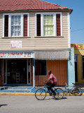 Man Riding Bike Through Black River Town