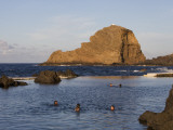 People in Natural Swimming Rock Pools and Ilheu Mole Island