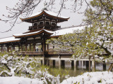 Snow Covered Chinese Style Bridge over Pond in Garden of Heian Shrine