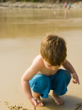 Young Boy Drawing in Sand at Little Cove
