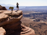 Woman on Ledge Looking at Green River Canyon Landscape from Grand View Point Overlook