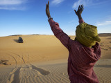 Tuareg Man Guiding 4Wd Car Through Soft Sand Dune