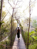 Woman Crossing Bridge Between Lobby and Accomodation Area at Four Seasons Tented Camp