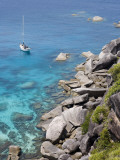 Sailboat and Snorkelers Near Granite Rocks