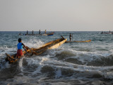 Fishermen Paddling their Vessels Out from Kollam Beach  Heading Out for Night Shift