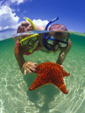 Two People Snorkelling with Starfish