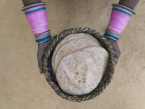 Overhead of Woman Holding a Bakset of Chapatis