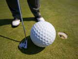 Man Playing Golf with Oversized Ball