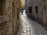 Scooter Riding Down Cobbled Backstreet