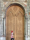 Young Turkish Woman Walking Past an Ornate Doorway in Ortakoy