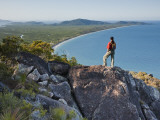 Woman Looking Down over Island from Rock Ridge