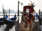 Masked Person in Costume by Gondolas Near St Mark's Square