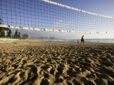 Person Jogging Near Volleyball Net on Manly Beach  Early Morning