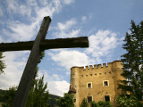 Cross and Herbst Castle in Dolomites Mountains