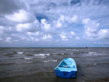 Fishing Boat on Caribbean Coast under Cloudy Sky
