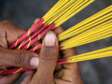 Close-Up of Woman's Hands Holding Incense Sticks