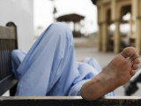 Man Resting on Park Bench in Bur Dubai
