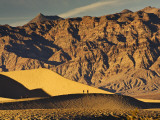 Hikers at Mesquite Flat Sand Dunes Marred by Footprints with Amargosa Range in Background
