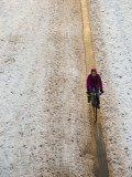 Woman Riding Bicycle on Path in Park in Winter