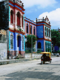 Brightly Coloured Buildings and Motorcycle Taxi
