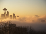 Morning Fog around Skyline with Sihouette of Space Needle and City Buildings