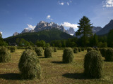 Haystacks in Field with Croda Rossa Dolomite Peaks in Distance