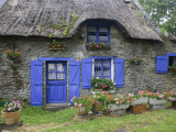 Thatched Cottage with Blue Doors  Windows and Pots of Geraniums Near Marzan
