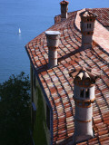 Tiled Rooftops of Duino Castle with Sailing Boat