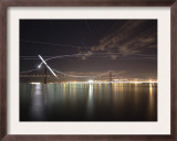 The Path of the Crescent Moon as it Sets over the Ponte 25 De Abril Bridge in Lisbon  Portugal