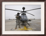 An Oh-58D Kiowa Warrior Pilot Stands Beside His Aircraft