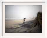 Beachgoer Walks Along an Eroded Section of Robert Moses State Park Beach in Babylon  New York