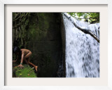 Child from the Ache Indigenous Group Plays Near a Waterfall in Cerro Moroti  Paraguay