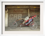 Indian Rickshaw Puller Rests in the Shade at a Closed Market Complex in New Delhi  India
