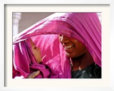 A Woman Shields Her Child from the Sun Using Her Scarf