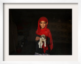 Girl Holds a Puppy as the Sun Sets over Kabul's Impoverished Teppe Maranjan Neighborhood