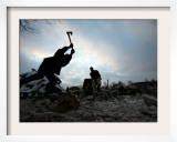 Man Chops Firewood at an Open Air Wood Market Near the Bulgarian Capital Sofia
