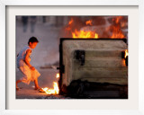 Bahraini Child Plays Near to Burning Tires and a Dumpster