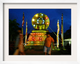 Children Walk Past an Illuminated Statue of Lord Buddha