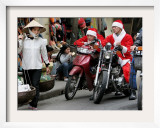 Vietnamese Men Dressed as Santa Claus Wait on their Motorbikes on a Street in Hanoi  Vietnam