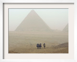 Tourists Ride Camels Through a Dust Storm at the Site of the Great Pyramids