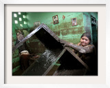 A Woman Tries to Salvage Belongings from Her Flooded House