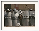 A Policeman Peeks from Behind His Shield