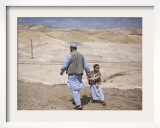 Palestinian Father and Son Walk in Desert During Celebrations Marking the Annual Day of Nebi Musa