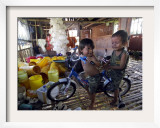 Children Play with a Bicycle Inside a Chicken Shed at Bobokan Tempel Village