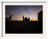 A UH-60 Black Hawk Crew Carry Out a Mission Brief at Sunset