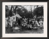 Three Sumo Wrestlers Posed Outdoors with Spectators in Background  Probably in Japan  1905
