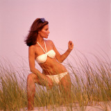 Young Woman  is Posing in Field Wearing White Bikini and Sunglasses